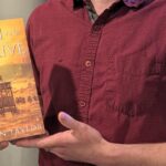 Author Stephen Taylor holding his epic fantasy book Glyph and Glaive